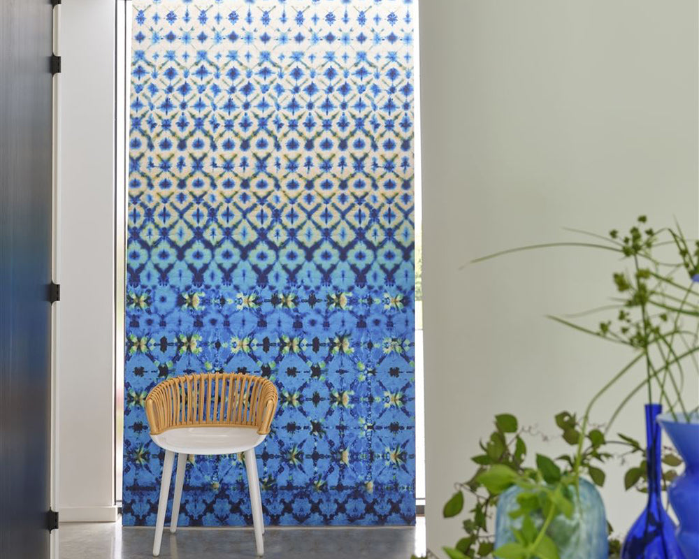 Designers Guild Karaoshi Wallpaper on a wall behind a stylish chair