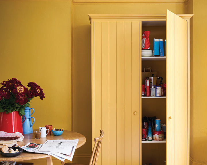 India Yellow 66 paint by Farrow & Ball on walls and woodwork in a dining room