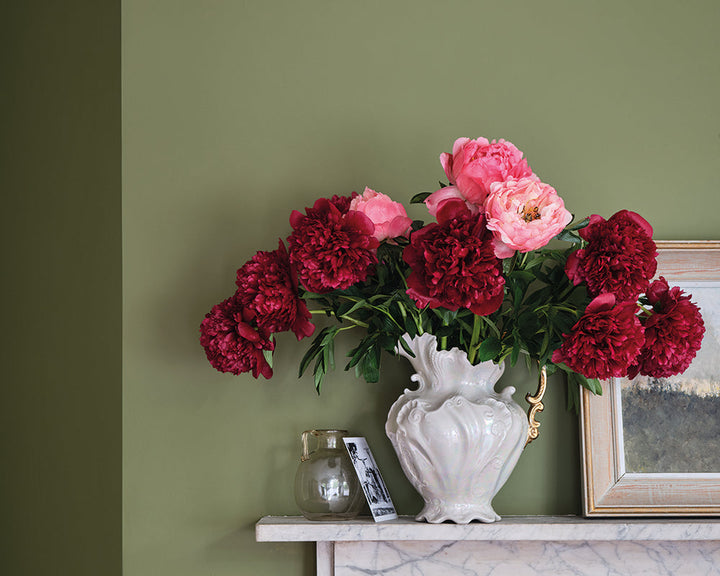 Farrow & Ball Sap Green W56 Paint used on a wall with a mantlepiece