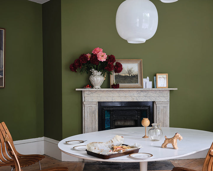 Farrow & Ball Sap Green W56 Paint in a dining room with modern furnishings