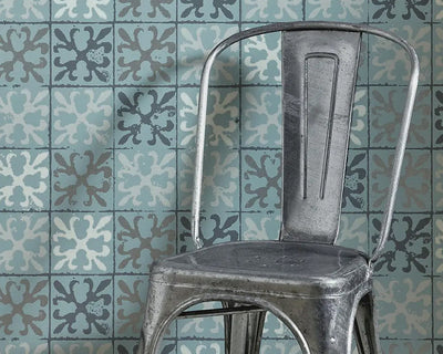 Barneby Gates Fleur de Lys Tile Wallpaper in Canteen blue with a chair