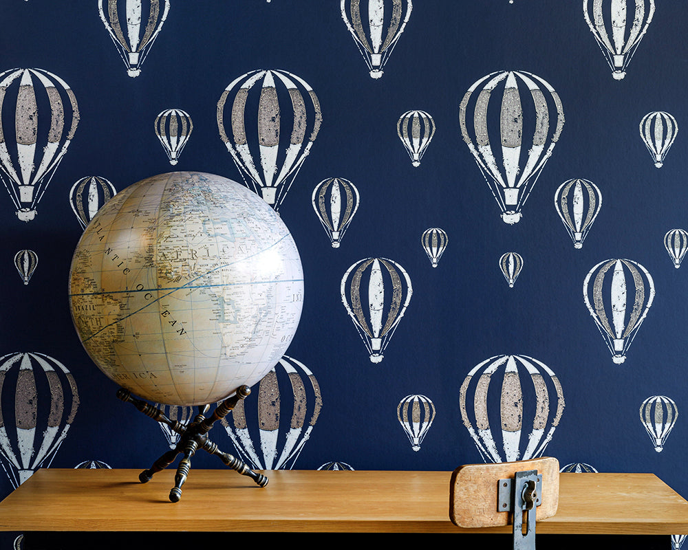 Barneby Gates Hot Air Balloon Wallpaper on a wall with a globe