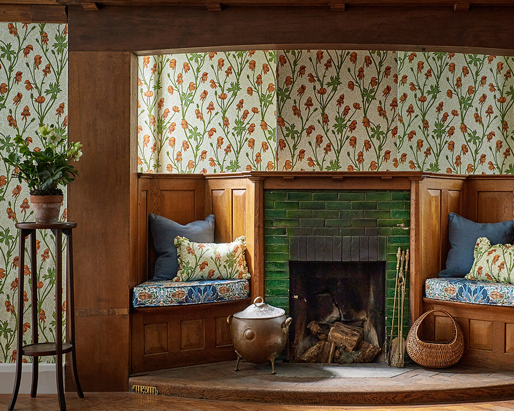Morris & Co Monkshood Wallpaper in Tangerine & Sage in a living room set up