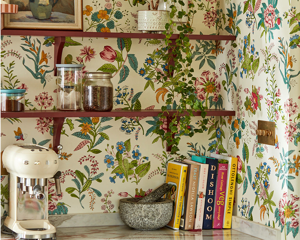 Harlequin Woodland Floral Wallpaper in Peridot/Ruby/Pearl in a kitchen set up as a shelves backdrop