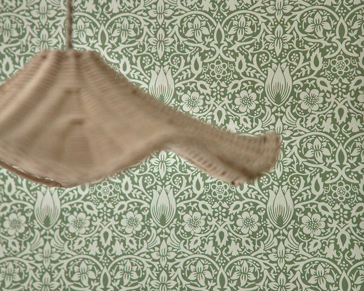 Morris & Co Borage Wallpaper with a wicker lampshade