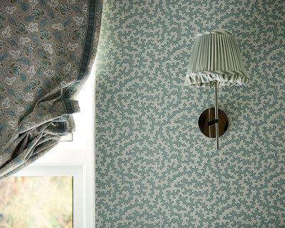 Sanderson Truffle Wallpaper in a living room with a wall light