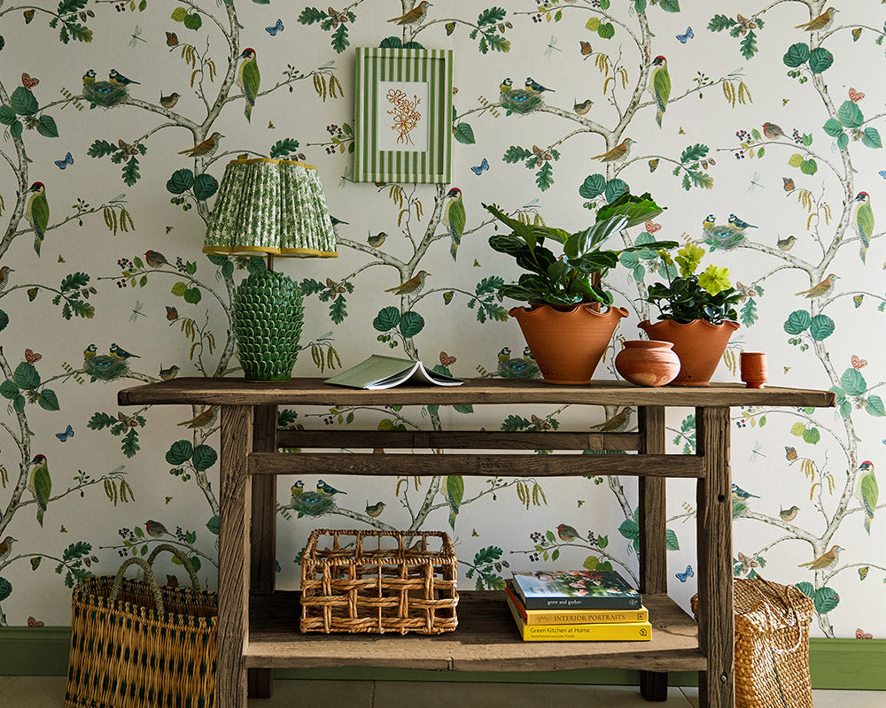 Sanderson Woodland Chorus Wallpaper behind a wooden side table