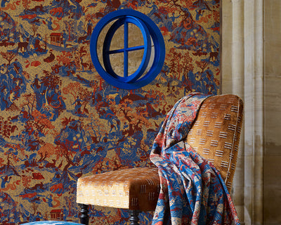 Zoffany Avalonis Wallpaper with a burnt orange chair